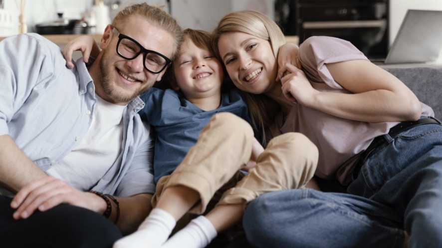 family laughing on the couch